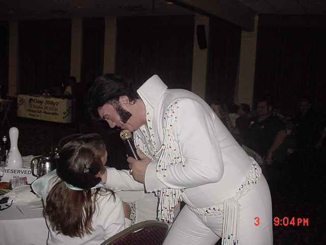 Singer singing in white sparkle cloths